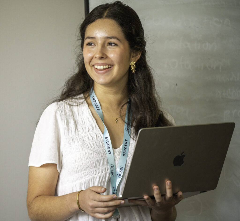 Student girl smiling with laptop during summer school, summer boarding courses, educational camp, learning, study abroad, international student, academic program, student life, summer education, language course relevance.